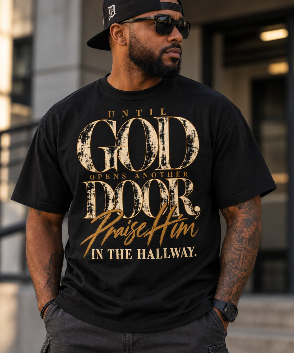 Man wearing Until God Opens Another Door black graphic tee